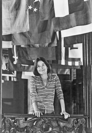 Portrait of Lisa Suter Taylor standing in front of an exhibit at the Cooper-Hewitt Museum.