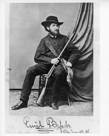 Card of Bessels in a uniform and holding a gun. 