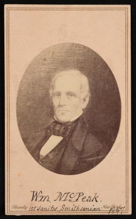 Portrait of a man with short, white hair. Underneath the portrait reads: Wm. McPeak 1st Janitor Smit