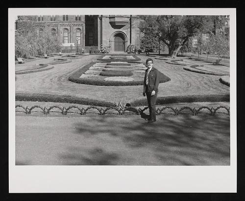 View of a man standing in front of the Victorian Garden.