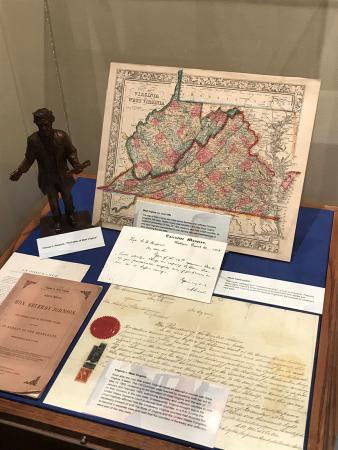 Image of documents and a map on display. The map is of Virginia and West Virginia. 