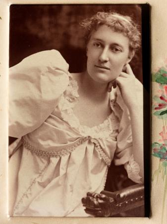 Eliza R. Scidmore posing in white gown, 1895.