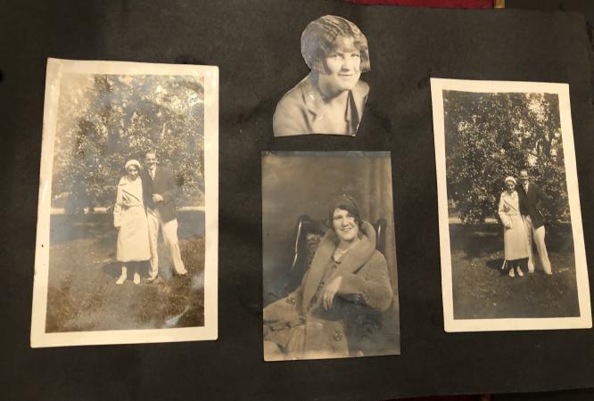 A page from an early 20th century scrapbook. Four black and white family portrait photographs have b
